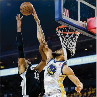  ?? THEARON W. HENDERSON / GETTY IMAGES ?? JaVale McGee of the Warriors blocks the shot of LaMarcus Aldridge in Game 1 of the first-round playoff series Saturday night. Golden State won 113-92 in Oakland, with Game 2 on Monday night.