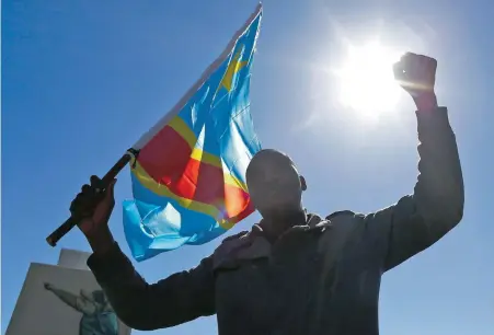  ?? PICTURE: EPA ?? FLAG-BEARER: A Democratic Republic of Congo national marches on an anti-xenophobia march organised by civil society groups.