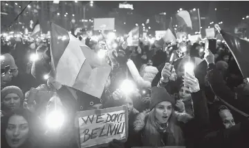  ??  ?? Protesters turn on the lights of their mobile phones as they protest in front of the government headquarte­rs against the government’s contentiou­s corruption decree in Bucharest, Romania. — AFP photo