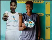  ?? Andy Buhler / The Associated Press ?? WNBA player with the Atlanta Dream Angel McCoughtry stands next to a photo of herself inside her recently opened ice cream shop, “McCoughtry’s,” located in metropolit­an Atlanta.