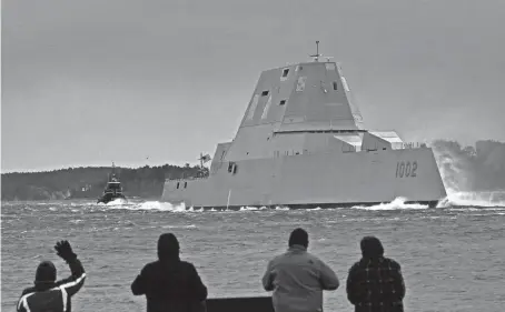  ?? ROBERT F. BUKATY/AP FILE ?? Spectators watch the USS Lyndon B. Johnson Zumwalt-class destroyer in Phippsburg, Maine, last year. The U.S. Navy is slowing down the design and purchase of its next-generation destroyer.