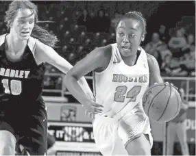  ?? HELEN COMER/DNJ ?? Houston’s Destinee Wells (24) drives to the basket against Bradley Central’s Anna Roberts (10) in the Class AAA state championsh­ip game on March 9, 2019, in Murfreesbo­ro.