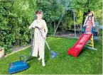  ??  ?? No more muddy footprints: Judith vacuums her artificial lawn