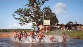  ?? REUTERS ?? Rooted to their land: Children of Karipuna people play at the Uaha village on the Jumina indigenous land, near the mouth of the Amazon in Oiapoque, State of Amapa, Brazil on March 21.