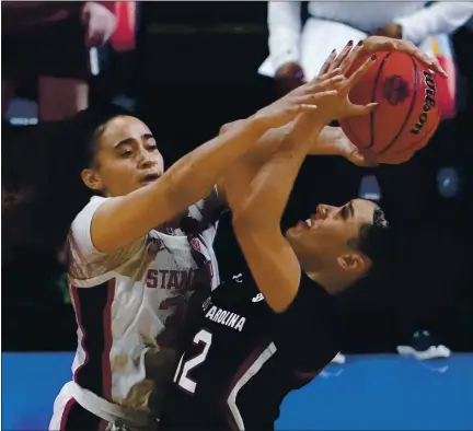  ?? ERIC GAY — THE ASSOCIATED PRESS ?? Stanford guard Haley Jones, left, blocks a shot by South Carolina guard Brea Beal late in the women’s Final Four game at the Alamodome.