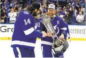  ?? CHRIS O'MEARA AP ?? Tampa Bay’s Steven Stamkos shows Pat Maroon (14) the Prince of Wales trophy after win over Rangers.