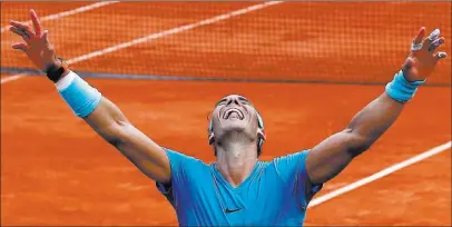  ?? Michel Euler ?? The Associated Press Rafael Nadal of Spain exults after winning his 11th French Open singles title Sunday with a 6-4, 6-3, 6-2 victory over Austria’s Dominic Thiem at Roland Garros in Paris.