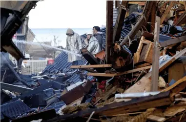  ?? ?? ABOVE: Firefighti­ng efforts in Japan's Ishikawa prefecture following the 7.6 magnitude earthquake that struck the country on 1 January. BELOW: Michel Nostradamu­s, who some prophecy-watchers believe predicted the quake back in 1555.