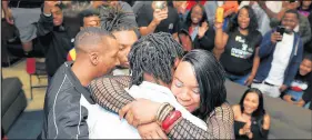  ?? VICTOR HILITSKI/CHICAGO TRIBUNE ?? Lonnie Johnson Jr. gets hugs from his mother Nora Johnson, father Lonnie Johnson Sr. and younger brother Darion Johnson after receiving news that he was drafted by the Houston Texans in the second round with the 54th overall selection on April 27 in Gary.