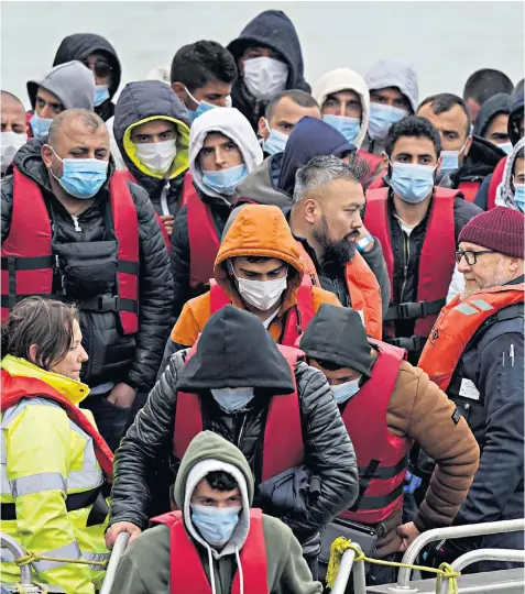  ?? ?? A group of migrants are brought in to Dover on a Border Force vessel, following an incident involving a small boat in the English Channel