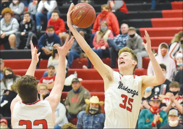  ?? RICK PECK/ SPECIAL TO MCDONALD COUNTY PRESS ?? McDonald County’s Eli McClain grabs a rebound during the Mustangs’ 48-43 loss to Neosho on Dec. 11 at McDonald County High School.