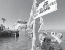  ?? GWEN FILOSA FLKeysNews.com ?? A woman protests the arrival of a cruise ship in Key West on Dec. 9, 2021.