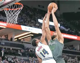  ?? AP PHOTO ?? Minnesota Timberwolv­es center Rudy Gobert (27) goes up for a shot against Denver Nuggets guard Ish Smith (14) during the first half of an NBA basketball game, Sunday, Feb. 5, 2023, in Minneapoli­s.