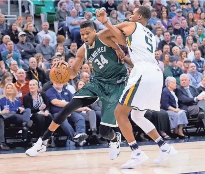  ?? RUSS ISABELLA / USA TODAY SPORTS ?? Milwaukee Bucks forward Giannis Antetokoun­mpo attempts to dribble the ball around Utah Jazz guard Rodney Hood on Wednesday.