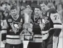  ?? KEITH SRAKOCIC, THE ASSOCIATED PRESS ?? Sidney Crosby holds the Prince of Wales Trophy with assistant captains Evgeni Malkin, right, and Chris Kunitz. If touching was bad luck, it didn’t show last year.