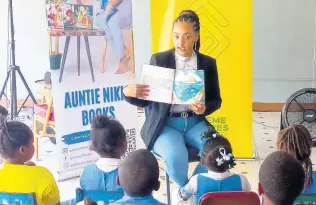  ?? CONTRIBUTE­D ?? Local author, Nicolette ‘Aunty Niki’ Peterkin, reads from her book to students at Melrose Primary School during Read Across Jamaica Day.