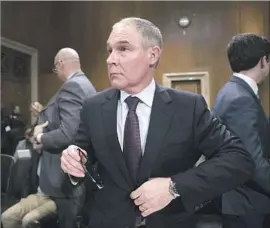  ?? J. Scott Applewhite Associated Press ?? SCOTT PRUITT, a longtime foe of environmen­talists, won in the Senate by a 52-46 vote with the support of two politicall­y vulnerable coal-country Democrats.