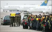  ?? UKRAINIAN PRESIDENTI­AL PRESS OFFICE VIA AP ?? Honor guard carry a coffin of one of the 11Ukrainia­n victims of the Ukrainian 737-800 plane that crashed on the outskirts of Tehran, at Borispil internatio­nal airport outside Kyiv, Ukraine.