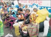  ?? ANI ?? Migrants labourers’ family members wait to board a bus in Mumbai on Tuesday.