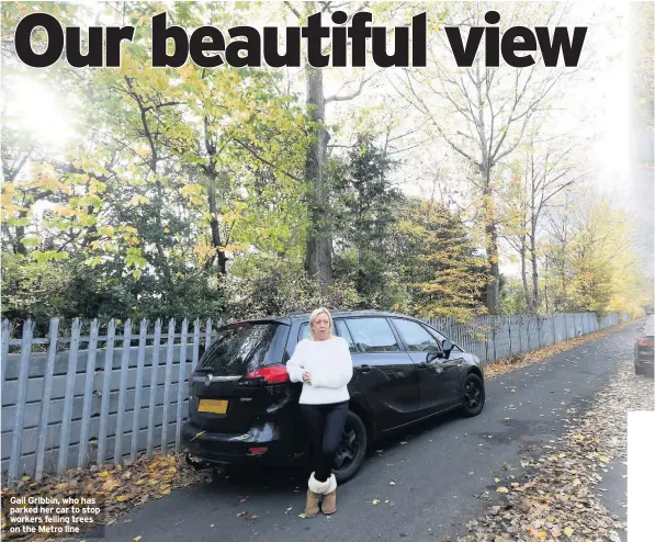  ??  ?? Gail Gribbin, who has parked her car to stop workers felling trees on the Metro line