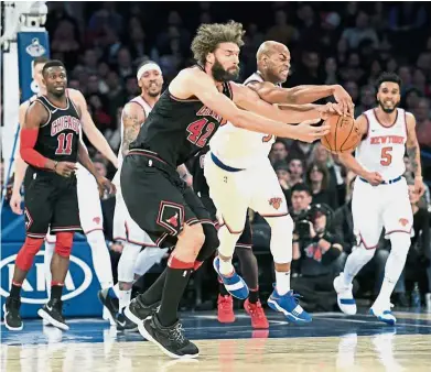 ??  ?? That’s mine: New York Knicks guard Jarrett Jack (second from right) vying for the ball with Chicago Bulls centre Robin Lopez.