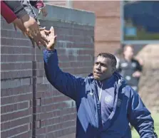  ?? STAFF PHOTO BY MATT HAMILTON ?? Chattanoog­a FC coach Rod Underwood gets high-fives from fans before a home match in March.