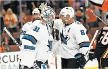  ?? Sean M. Haffey / Getty Images ?? Joe Pavelski congratula­tes goalie Martin Jones after the Sharks beat the Ducks in Anaheim on Saturday for a 2-0 series lead.