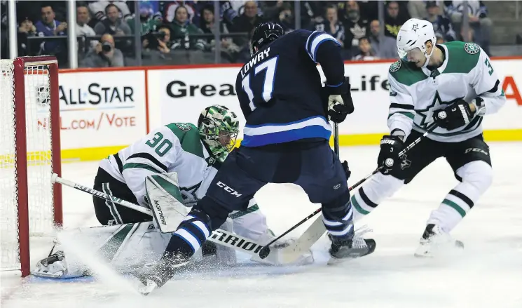  ?? — KEVIN KING ?? Jets centre Adam Lowry tries to jam a loose puck past Stars goalie Ben Bishop on Sunday in Winnipeg. Lowry had a goal in a 5-1 Jets’ victory.