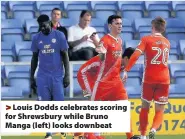  ??  ?? > Louis Dodds celebrates scoring for Shrewsbury while Bruno Manga (left) looks downbeat