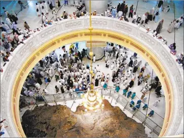  ?? Amr Nabil Associated Press ?? MUSLIM pilgrims pray near Safa hill at the Grand Mosque during last year’s hajj in Mecca, Saudi Arabia. The hajj, which traditiona­lly draws about 2 million people each year, is set to begin this year at the end of July.