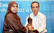  ?? ?? Best Healthcare and Medical Reporter of the Year (2019 - Tamil stream): Mohamed Hussain Fathima Husna of the Thinakural receives the award from Ranjith Ananda Jayasinghe