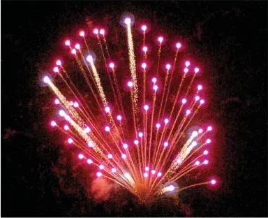  ?? MARK HUMPHREY/ENTERPRISE-LEADER ?? Stan Cook, of Prairie Grove, wowed the crowd with a fireworks show Saturday. The fireworks created a cloud of smoke over the Prairie Grove aquatic park — reminding Americans of the birth of our national anthem during the Battle of Baltimore in 1814.