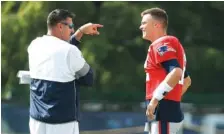  ??  ?? Tennessee Titans coach Mike Vrabel, left, talks with New England Patriots quarterbac­k Tom Brady during the teams’ combined practice Wednesday in Nashville. Vrabel, who won three Super Bowl rings with the Patriots, and Brady were teammates for nine seasons.