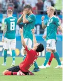  ?? LEE JIN-MAN/THE ASSOCIATED PRESS ?? Germany’s players walk off the pitch as South Korea’s Ju Se-jong, front, celebrates their win.