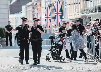  ?? JACK TAYLOR GETTY IMAGES ?? Police officers patrol ahead of a dress rehearsal of the wedding of Prince Harry and Meghan Markle outside Windsor Castle.