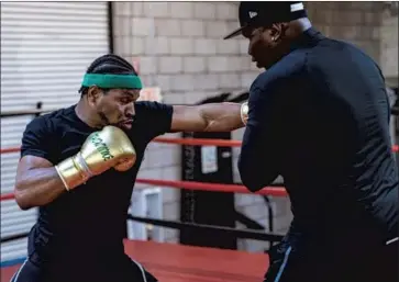  ?? Photograph­s by Premier Boxing Champions ?? “I APPRECIATE and love the way I grew up,” said Shawn Porter, left, working out with his father-trainer Kenny in preparatio­n for tonight’s fight against unbeaten Sebastian Formella at the Microsoft Theater.