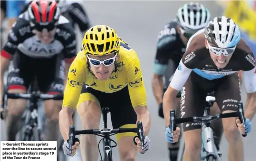  ??  ?? &gt; Geraint Thomas sprints over the line to secure second place in yesterday’s stage 19 of the Tour de France