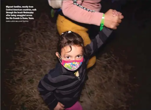  ?? DARIO LOPEZ-MILLS/AP PHOTOS ?? Migrant families, mostly from Central American countries, walk through the brush Wednesday after being smuggled across the Rio Grande in Roma, Texas.