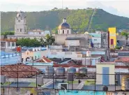  ?? COURTESY OF CHARLES BENNETT ?? The skyline of Holguín, Cuba, is set against the backdrop of La Loma de La Cruz, which has 465 steps leading to its summit. The hill and pilgrimage­s to the top are the focus of a fiesta in May.