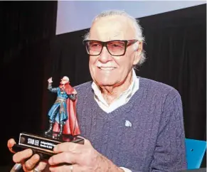  ??  ?? Real life superhero: Lee, seen here with his custom Hasbro Marvel Legends figure, is keen on promoting respect among the people. — AP