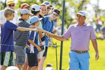  ?? THE ASSOCIATED PRESS ?? Jason Dufner greets fans as he walks to the 18th tee Friday during the second round of the Memorial tourney in Dublin, Ohio. Dufner finished the day at 14-under-par 130, giving him the tourney’s 36-hole scoring record and a five-shot lead.