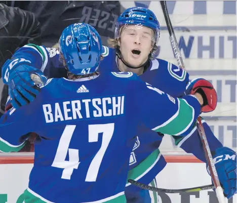  ?? THE CANADIAN PRESS ?? Sven Baertschi hugs teammate Brock Boeser after the rookie scored against the Vegas Golden Knights during Thursday night’s 5-2 loss in Vancouver. Boeser is now in the thick of the rookie-of-the-year conversati­on and is a 20-year-old star in the making,...