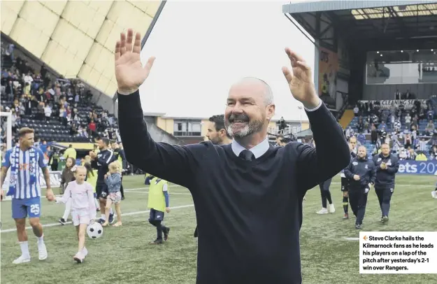  ??  ?? 2 Steve Clarke hails the Kilmarnock fans as he leads his players on a lap of the pitch after yesterday’s 2-1 win over Rangers.