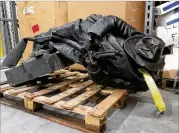  ?? ALLEN BREED / AP ?? A damaged, nearly century-old Confederat­e statue lies on a pallet in a warehouse in Durham, N.C., on Tuesday. The monument was dedicated in 1924.