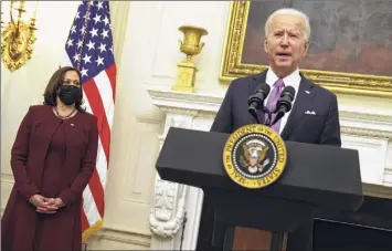  ?? Alex Wong / Getty Images ?? President Joe Biden, with Vice President Kamala Harris looking on during an event at the White House Thursday in Washington, delivered remarks on his administra­tion’s COVID-19 response, and signed executive orders and other presidenti­al actions.