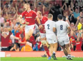  ?? Photo / Getty Images ?? George North celebrates scoring Wales’ try.