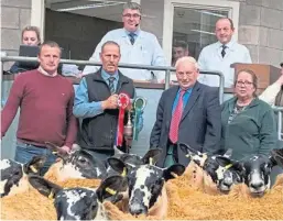  ??  ?? Winner of the champion pen Mark Smyth, shepherd J McDougall, Alan Ross and J Connor. Behind are retiring auctioneer Matt Stevenson and United Auctions managing director George Purvis.