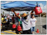  ?? AP/DAVID GOLDMAN ?? Alex Williamson celebrates after making it to the front of the line before gas ran out while waiting for over three hours in the aftermath of Hurricane Michael on Monday in Callaway, Fla.