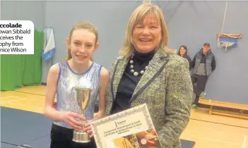  ??  ?? Accolade Rowan Sibbald receives the trophy from Janice Wilson