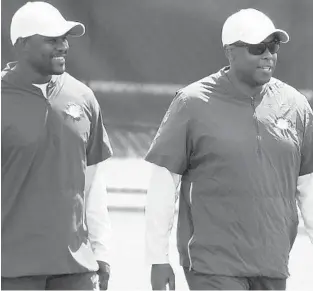  ?? JOE CAVARETTA/SUN SENTINEL ?? Dolphins coach Brian Flores and general manager Chris Grier.